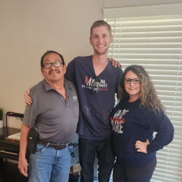 two men and a woman posing for a picture